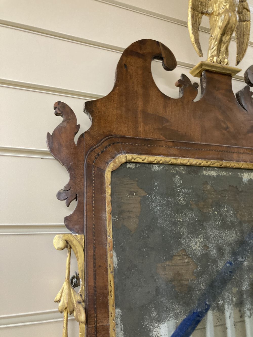 A George II parcel gilt walnut fret cut wall mirror, width 56cm height 120cm